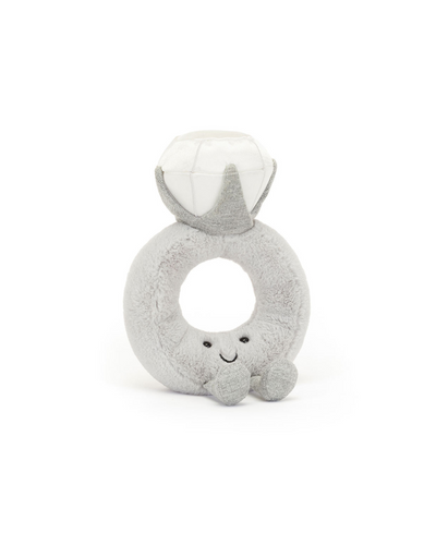 The Jellycat Amuseables Diamond Ring is a plush toy shaped like a diamond ring, featuring a soft grey band, shiny white diamond top, and a smiling face with small arms and feet at the base.