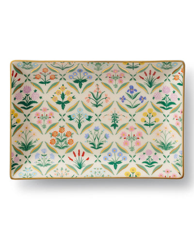 The Estee Catchall Tray is a porcelain dish with a vibrant repeating floral pattern and green leaves on a cream background, finished with a gold rim—ideal for adding charm as a decorative or catchall tray.