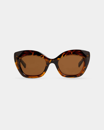 Oversized cat-eye sunglasses with a tortoiseshell frame and brown-tinted lenses, displayed against a white background.
