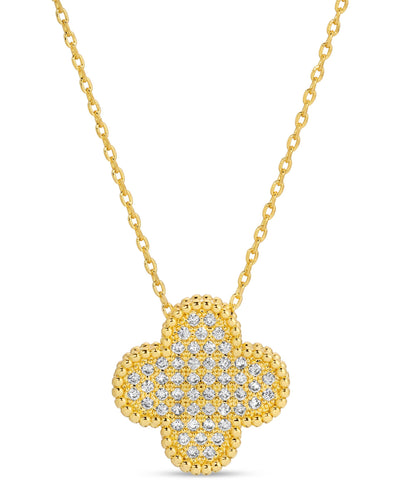 A gold-plated quatrefoil pendant necklace encrusted with sparkling pave cubic zirconia, suspended from a delicate gold chain against a white background.