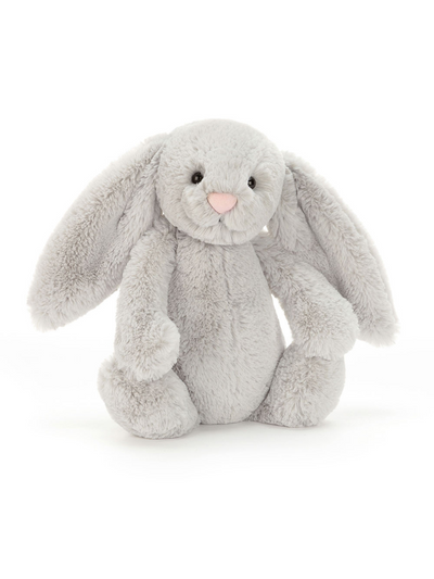 A plush Jellycat Bashful Silver Bunny in a soft gray color with long floppy ears, a pink nose, black beaded eyes, and a cuddly appearance, sitting upright.