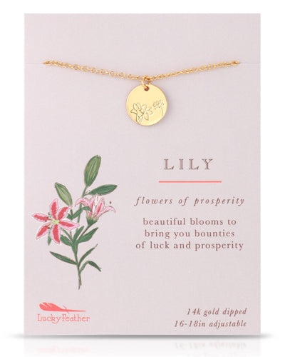 A delicate gold-dipped necklace featuring a circular pendant etched with a lily design, symbolizing prosperity. Displayed on a card with an illustration of lilies and the phrase "Flowers of Prosperity."