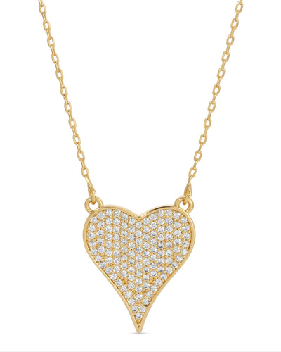 The Pave Heart Necklace - Gold features an 18k gold heart pendant adorned with shimmering diamonds on a delicate chain, elegantly capturing the light.