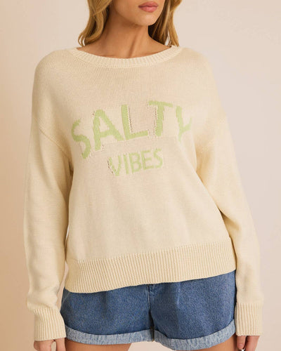 A cream-colored lightweight sweater with 'Salty Vibes' text in light green, featuring a relaxed fit, round neckline, and soft knit fabric, perfect for beach lovers and coastal fashion.