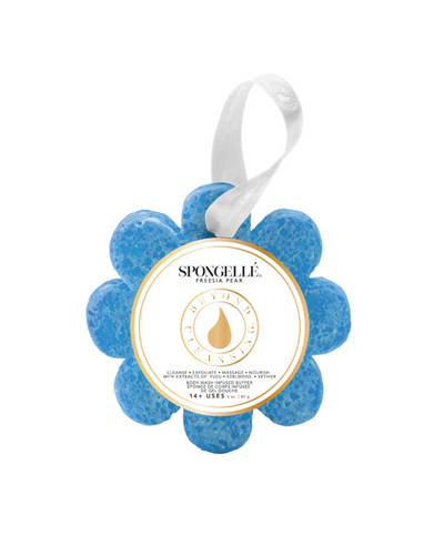 A blue, flower-shaped Spongelle Wild Flower - Freesia Pear body wash infused buffer features a white ribbon handle and a center label showcasing its patented exfoliating massage technology.