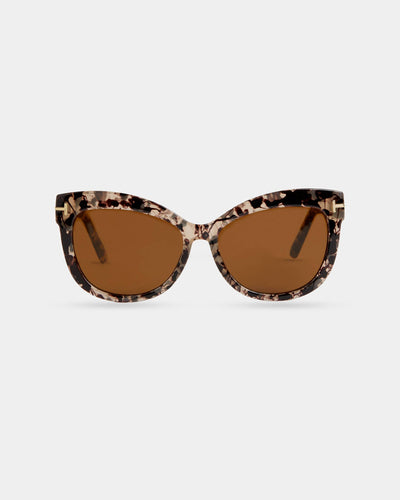 A pair of oversized cat-eye sunglasses with a marbled tortoise frame, brown lenses, and gold-tone detailing on the temples.