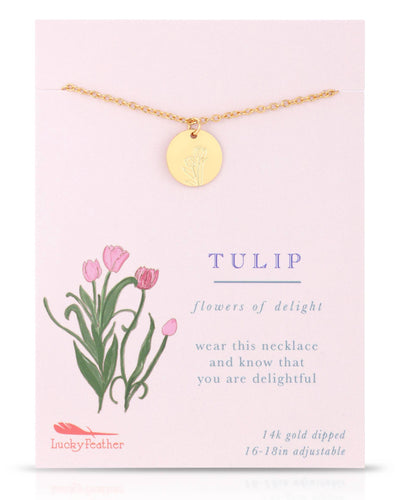A graceful gold-dipped necklace with a circular pendant etched with a tulip design, symbolizing delight. Shown on a card featuring tulip illustrations and the phrase "Flowers of Delight."
