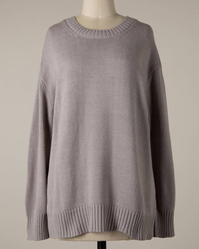 A silver pullover sweater displayed on a mannequin against a plain background. The Lyla cable knit ribbed soft pullover sweater features a round neckline and long sleeves, with ribbed cuffs and hem.