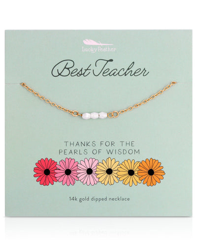 The Spring Celebrations Necklace features white pearls on a green card with colorful flowers labeled "Best Teacher" and "Thanks for the Pearls of Wisdom." Crafted in a 14k gold dipped, nickel-free design, it's the perfect teacher gift.