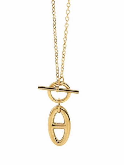 The Agatha Toggle Necklace - Gold features an 18k thin chain with a tarnish-resistant, oval-shaped pendant and horizontal bar. It has a circular loop attachment and toggle bar closure, offering elegance and hypoallergenic benefits.